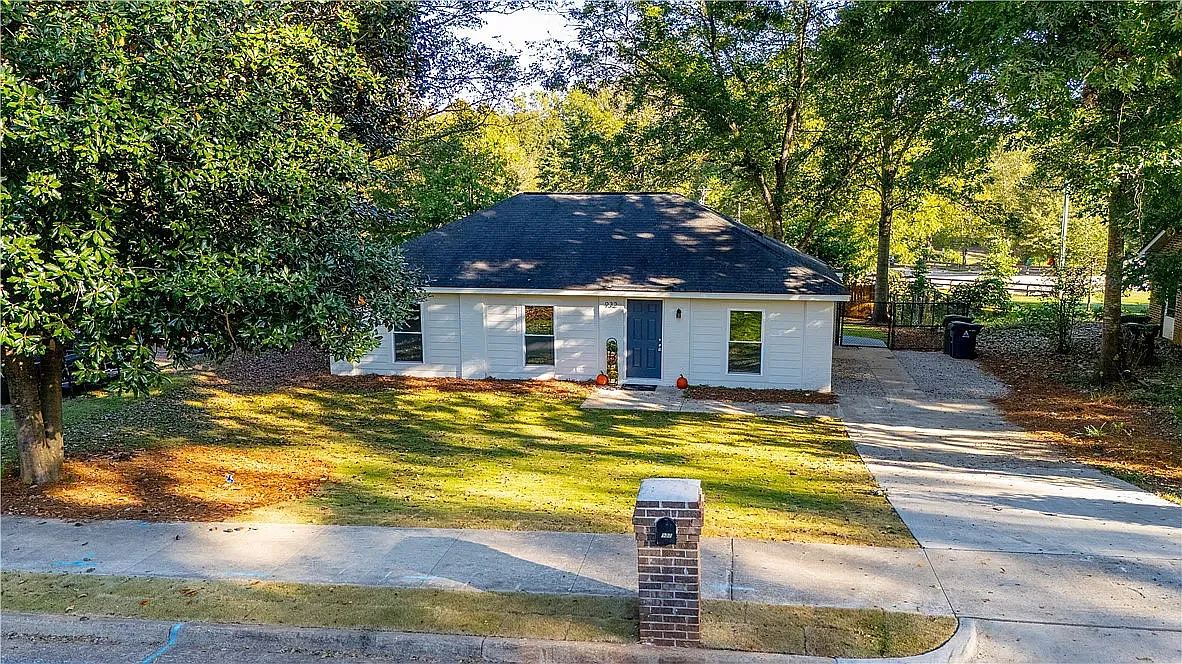 Brick single family rental home with a front lawn